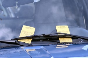 Two parking tickets, tucked beneath a single windshield wiper, await a likely angry driver when he returns to his vehicle on a street in downtown Doylestown PA. 2008-04-05.